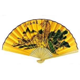 Bamboo fan with tiger silk on a golden background