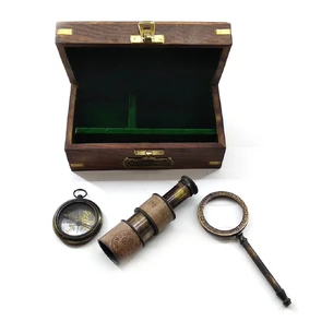A magnifying glass with a compass and a spyglass in a wooden case (16.5x9.5x7.5 cm)A