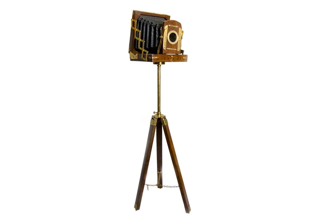 Фото 1 - A souvenir camera on a tripod.